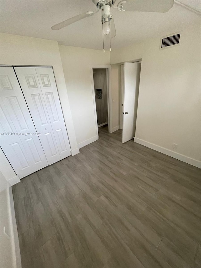 9851 Sandalfoot Blvd Unit 208, Boca Raton, FL 33428 - unfurnished bedroom featuring baseboards, dark wood-type flooring, and a ceiling fan