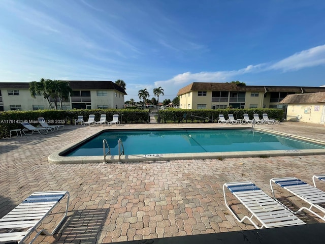9851 Sandalfoot Blvd Unit 208, Boca Raton, FL 33428 - community pool featuring a patio