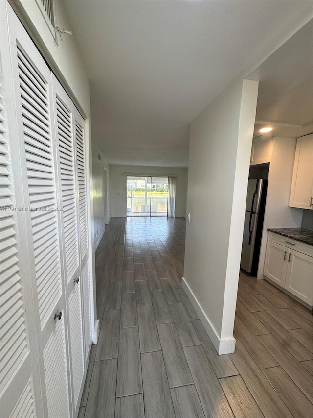 9851 Sandalfoot Blvd Unit 208, Boca Raton, FL 33428 - hall featuring dark wood-style flooring and baseboards