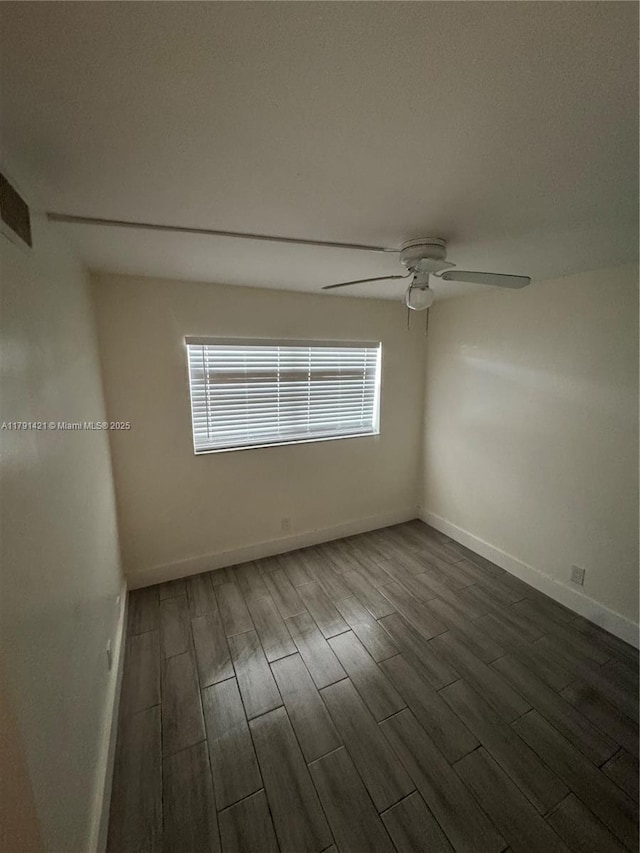 9851 Sandalfoot Blvd Unit 208, Boca Raton, FL 33428 - unfurnished room featuring dark wood-type flooring, ceiling fan, and baseboards