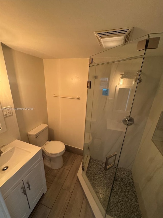 9851 Sandalfoot Blvd Unit 208, Boca Raton, FL 33428 - full bathroom with a stall shower, toilet, vanity, and wood finish floors