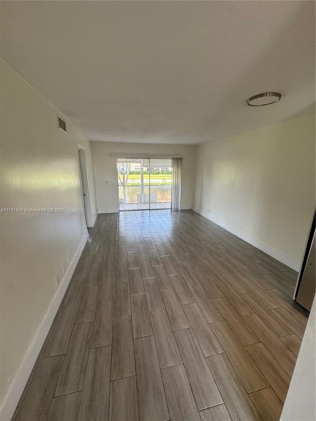 9851 Sandalfoot Blvd Unit 208, Boca Raton, FL 33428 - spare room featuring wood tiled floors and baseboards
