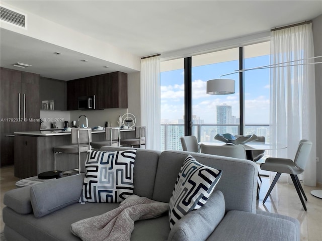 68 SE 6th St Unit 3611, Miami, FL 33131 - living room featuring a healthy amount of sunlight, floor to ceiling windows, a city view, and visible vents