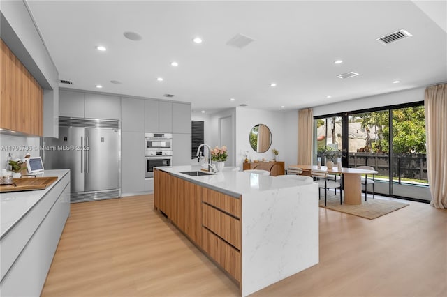 1509 SW 15th St, Miami, FL 33145 - kitchen featuring visible vents, stainless steel appliances, modern cabinets, and a sink