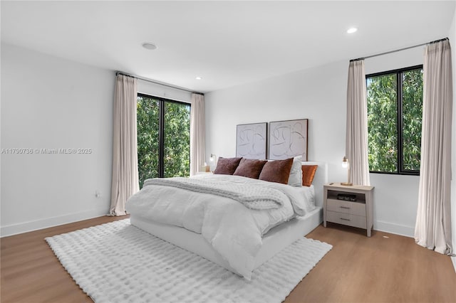 1509 SW 15th St, Miami, FL 33145 - bedroom with wood finished floors, baseboards, and multiple windows
