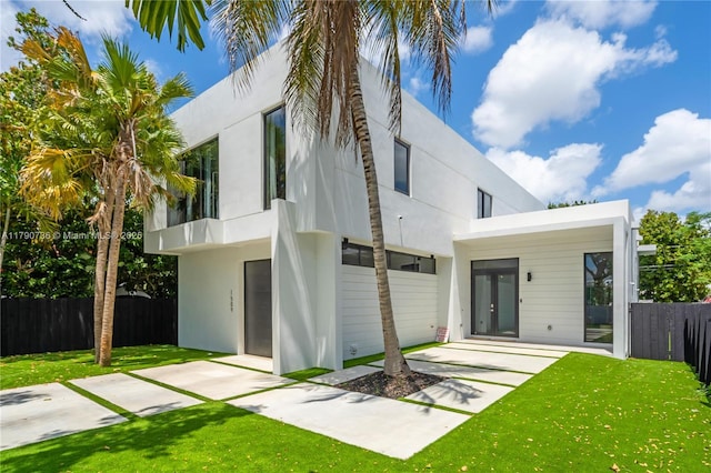 1509 SW 15th St, Miami, FL 33145 - rear view of house featuring a lawn, stucco siding, and fence