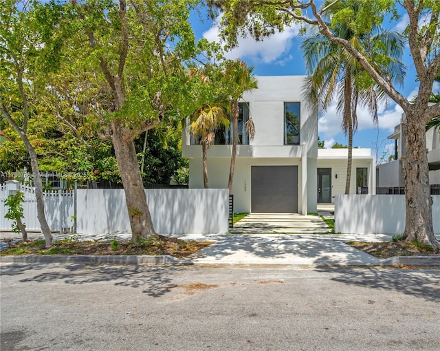1509 SW 15th St, Miami, FL 33145 - contemporary house featuring fence, driveway, stucco siding, and a garage