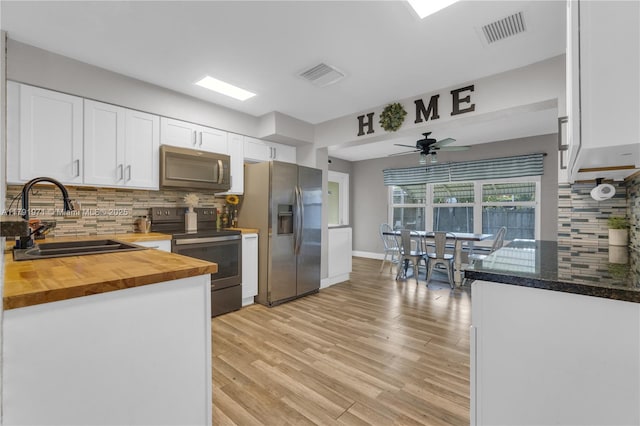 4649 SW 28th Ave, Dania Beach, FL 33312 - living room with light wood-type flooring, baseboards, a glass covered fireplace, and ceiling fan