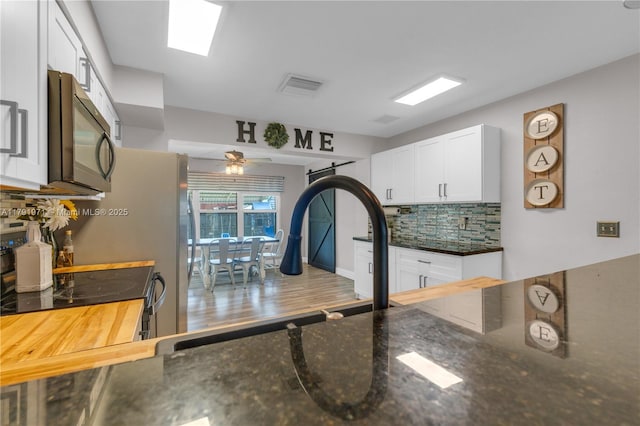 4649 SW 28th Ave, Dania Beach, FL 33312 - living area featuring ceiling fan, visible vents, a glass covered fireplace, and baseboards