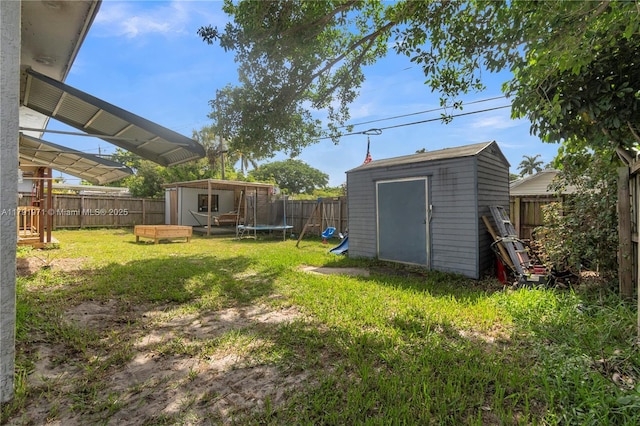 4649 SW 28th Ave, Dania Beach, FL 33312 - view of yard with a playground, a fenced backyard, and a trampoline