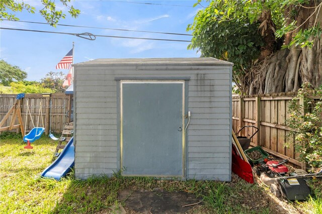 4649 SW 28th Ave, Dania Beach, FL 33312 - view of yard featuring an outbuilding, a fenced backyard, a trampoline, and a storage unit