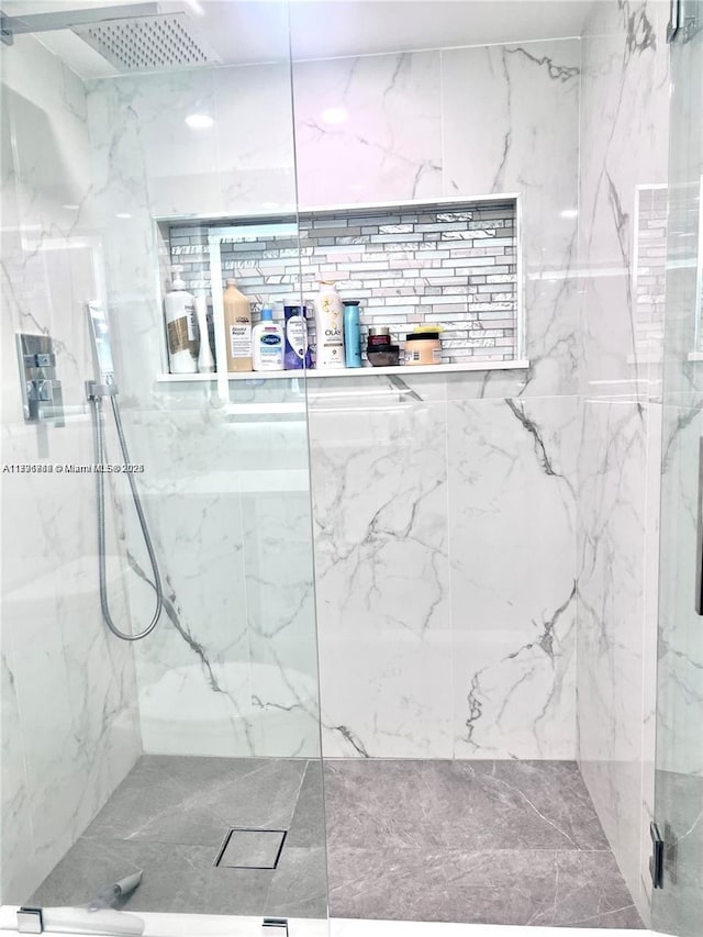 full bathroom featuring a marble finish shower