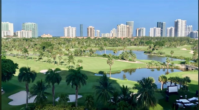 aerial view with a view of city, a water view, and golf course view
