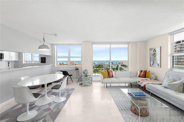living area featuring a textured ceiling and a wall of windows
