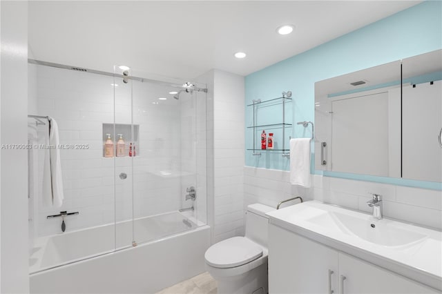 650 W Ave Unit 2102, Miami Beach, FL 33139 - bathroom featuring vanity, combined bath / shower with glass door, recessed lighting, and tile walls