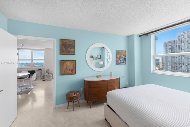 650 W Ave Unit 2102, Miami Beach, FL 33139 - bedroom featuring a textured ceiling, a view of city, and light tile patterned floors