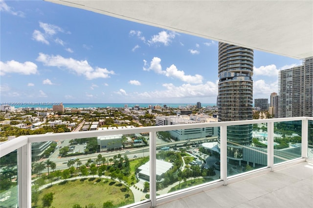 balcony featuring a view of city and a water view