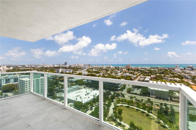 balcony with a water view and a city view
