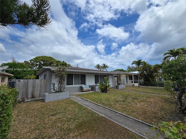 2281 NE 173rd St, North Miami Beach, FL 33160 - view of front of house featuring a front yard, stucco siding, and fence