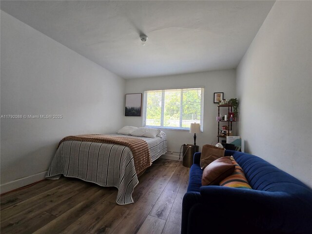 2281 NE 173rd St, North Miami Beach, FL 33160 - bedroom with dark wood-style flooring and baseboards