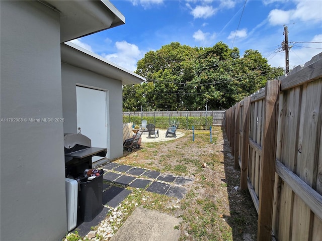 2281 NE 173rd St, North Miami Beach, FL 33160 - view of yard with a fire pit and a fenced backyard
