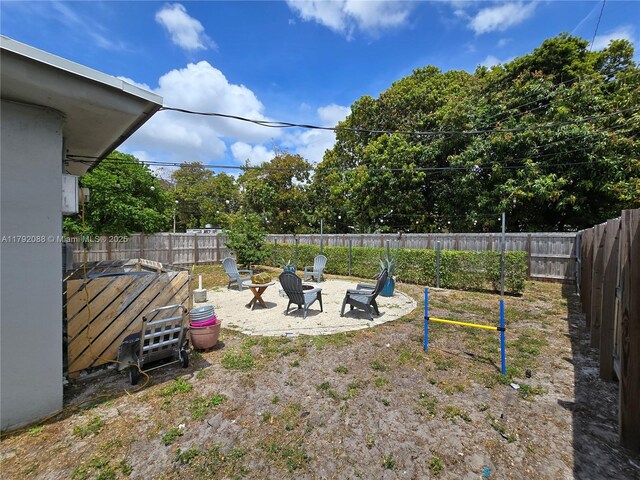 2281 NE 173rd St, North Miami Beach, FL 33160 - view of yard with an outdoor fire pit and a fenced backyard
