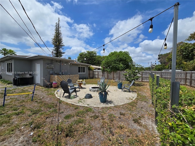 2281 NE 173rd St, North Miami Beach, FL 33160 - view of yard with a patio, a fenced backyard, and an outdoor fire pit