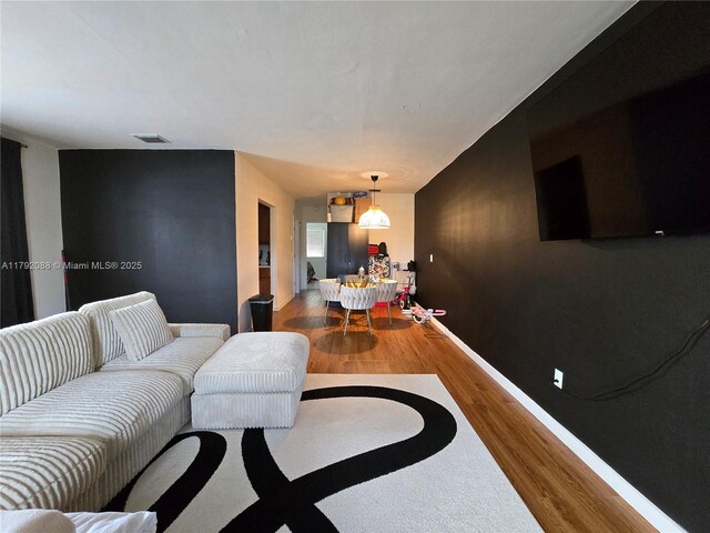 2281 NE 173rd St, North Miami Beach, FL 33160 - living area featuring wood finished floors, visible vents, and baseboards