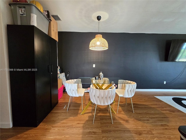 2281 NE 173rd St, North Miami Beach, FL 33160 - dining room with baseboards, visible vents, and wood finished floors