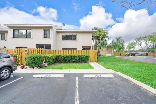 5000 S University Dr, Davie, FL 33328 - exterior space featuring a gate, uncovered parking, a front lawn, and a fenced front yard