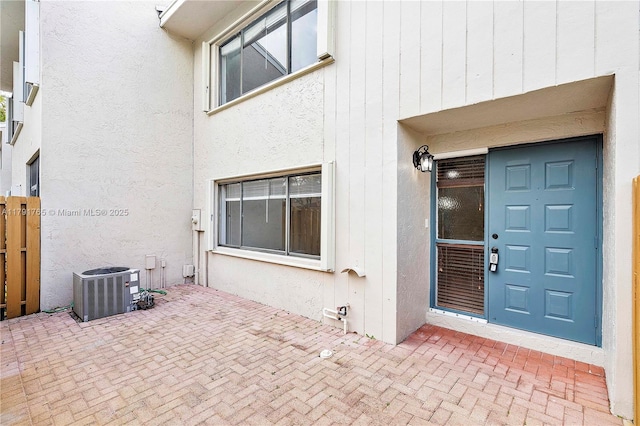 5000 S University Dr, Davie, FL 33328 - property entrance featuring fence, central AC unit, stucco siding, and a patio area