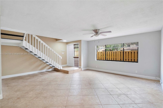 5000 S University Dr, Davie, FL 33328 - interior space featuring a textured ceiling, a ceiling fan, baseboards, and stairs