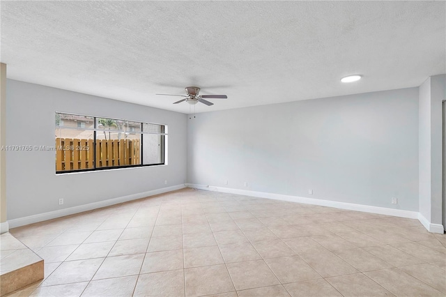 5000 S University Dr, Davie, FL 33328 - spare room with a textured ceiling, a ceiling fan, light tile patterned floors, and baseboards