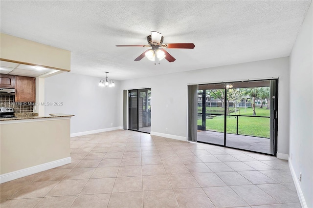 5000 S University Dr, Davie, FL 33328 - unfurnished living room featuring light tile patterned floors, baseboards, a textured ceiling, and ceiling fan with notable chandelier