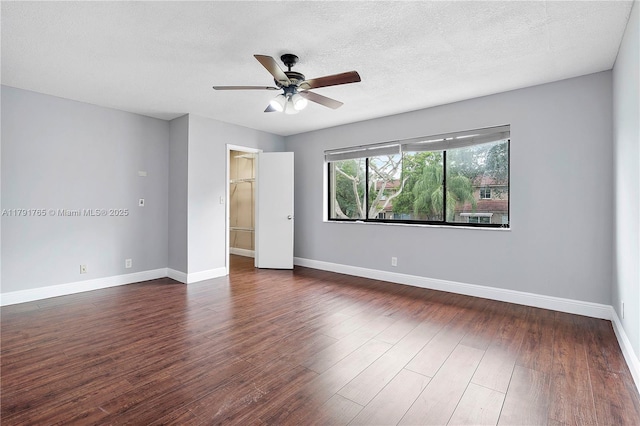5000 S University Dr, Davie, FL 33328 - unfurnished bedroom featuring a closet, a ceiling fan, baseboards, wood finished floors, and a spacious closet