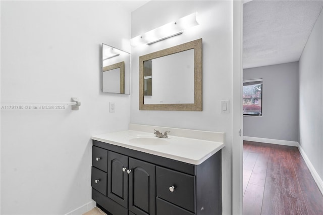 5000 S University Dr, Davie, FL 33328 - bathroom featuring a textured ceiling, wood finished floors, vanity, and baseboards