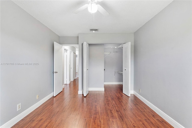 5000 S University Dr, Davie, FL 33328 - unfurnished bedroom featuring a closet, visible vents, wood finished floors, and baseboards