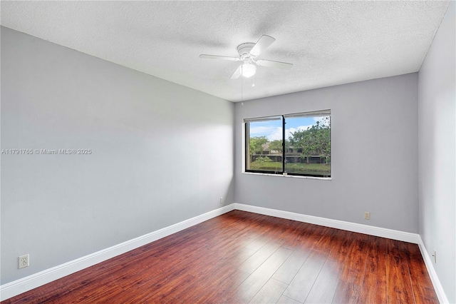 5000 S University Dr, Davie, FL 33328 - spare room featuring baseboards, wood finished floors, a ceiling fan, and a textured ceiling