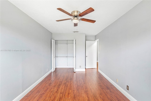 5000 S University Dr, Davie, FL 33328 - unfurnished bedroom with baseboards, wood finished floors, a ceiling fan, and a closet
