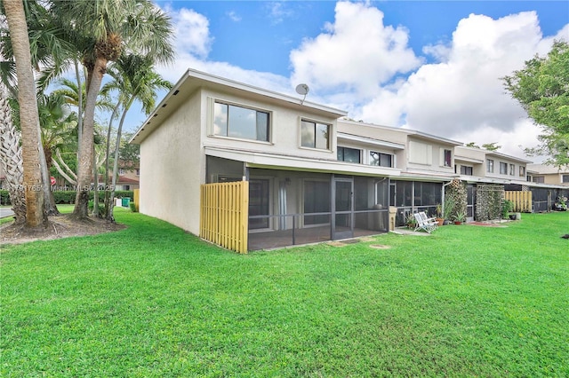 5000 S University Dr, Davie, FL 33328 - rear view of house featuring a yard, stucco siding, and a sunroom