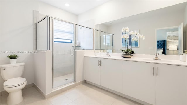 bathroom with tile patterned flooring, double vanity, toilet, a sink, and a stall shower