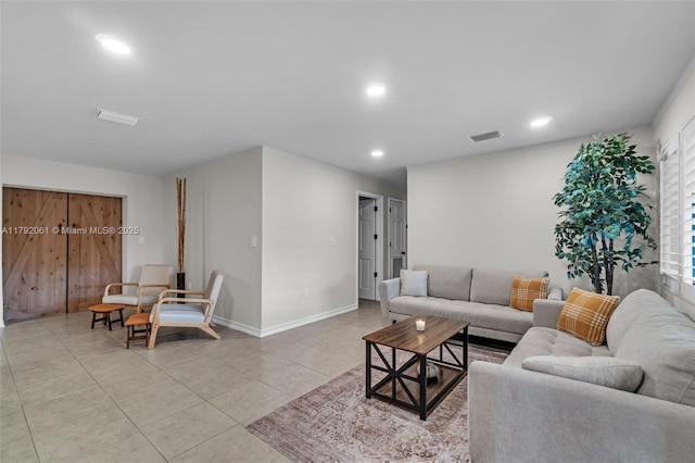 living area with light tile patterned floors, recessed lighting, visible vents, and baseboards