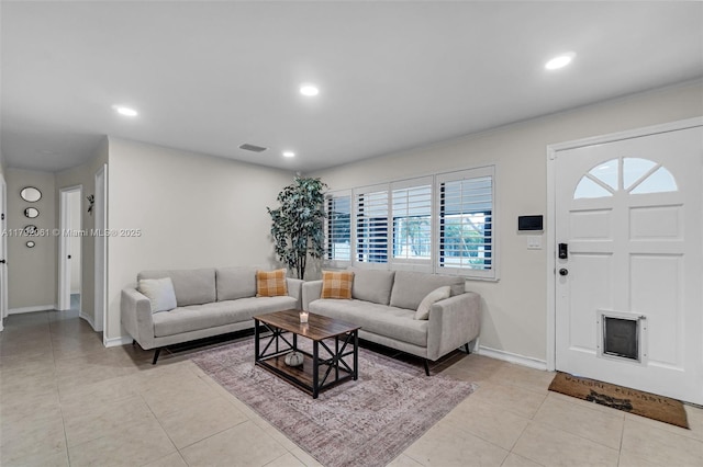 living area featuring light tile patterned floors, visible vents, recessed lighting, and baseboards