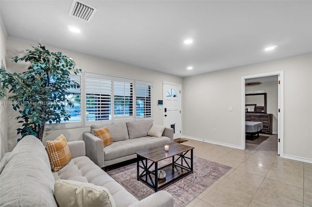 living room with baseboards, visible vents, light tile patterned flooring, and recessed lighting