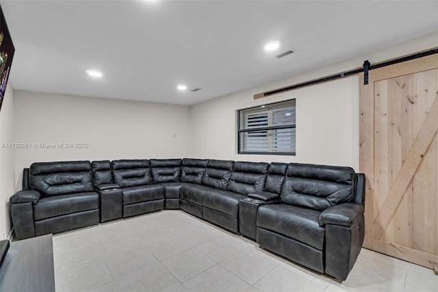 living area with visible vents, a barn door, light tile patterned floors, and recessed lighting