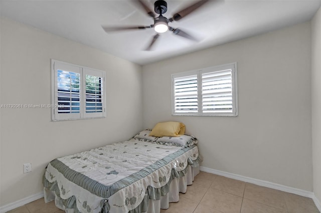 bedroom with tile patterned flooring, ceiling fan, and baseboards