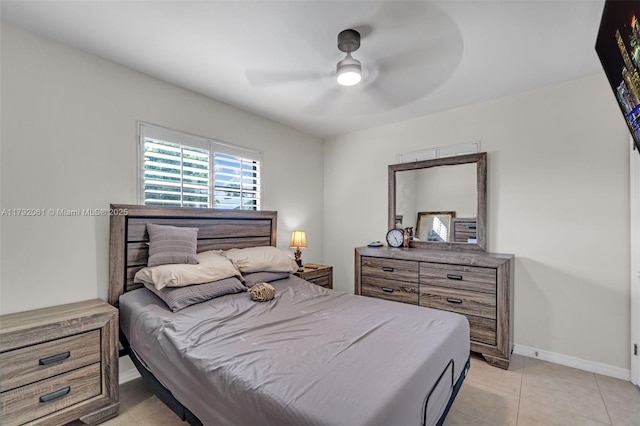 bedroom with baseboards, light tile patterned floors, and ceiling fan