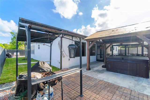 view of patio / terrace with a fenced backyard and a hot tub