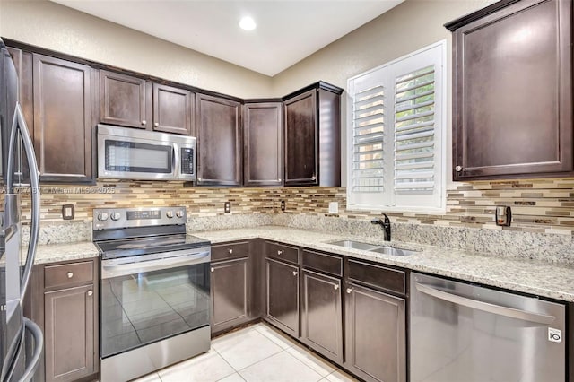 4343 Chalmers Ln, West Palm Beach, FL 33417 - kitchen with appliances with stainless steel finishes, backsplash, light tile patterned flooring, and dark brown cabinetry