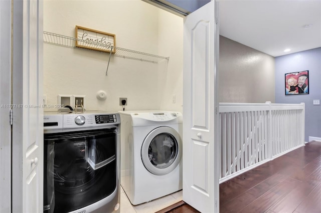 laundry area featuring baseboards, separate washer and dryer, recessed lighting, wood finished floors, and laundry area